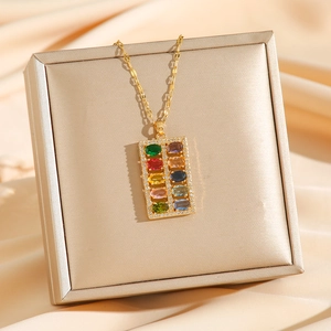 Colorful zircon abacus necklace with gold chain on silk background for luxury gift