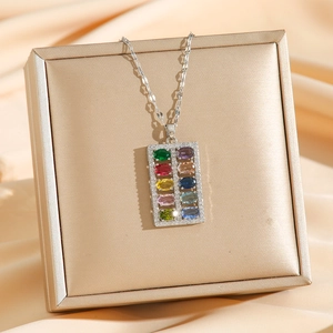 Luxe titanium steel necklace featuring a colorful zircon abacus pendant on gold satin