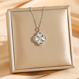 Elegant cat eye stone clover necklace with zircon trim on luxury champagne silk
