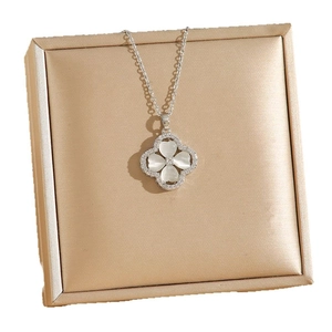 Elegant titanium steel necklace featuring a four-leaf clover opal pendant on a gold jewelry box