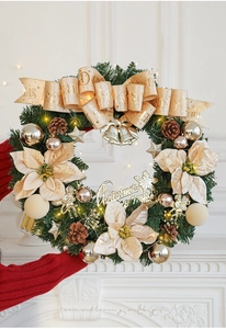 Detail of luxury Christmas wreath with champagne velvet flowers and warm LED lights