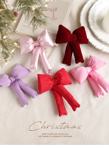Detail of assorted satin and velvet Christmas bows in various festive colors