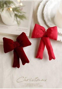 Detail of 3D padded velvet and satin Christmas bows on a festive decorative tray