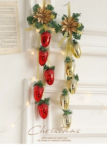 Close-up of Christmas pinecone ornaments with red and gold acorns and festive LED lights