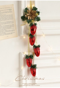 Red acorn Christmas hanging decoration with pine needles and warm glowing LED lights