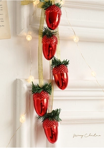 Red acorn ornaments with green pine needles and LED star lights for festive decor