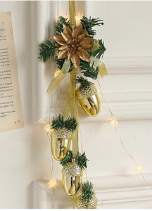 Close-up of golden pine cones ornaments with LED lights and festive decorations