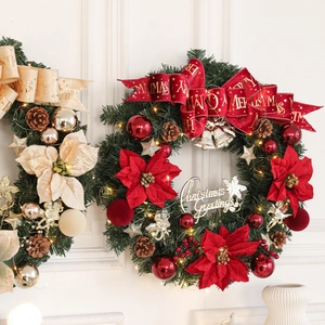 Lush Christmas wreath with red velvet bow, pine cones, and gold ornaments on white wall