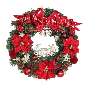 Illuminated Christmas wreath with red poinsettia flowers and golden bells on white background