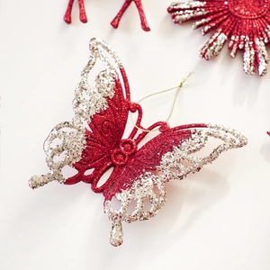 Macro detail of red glitter butterfly ornament with silver accents for Christmas tree