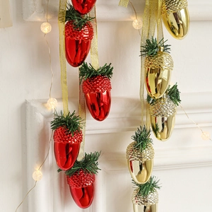 Christmas shiny acorn ornaments with pine needles and golden ribbons for festive decor