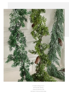 Detailed view of artificial ivy hanging vines with pine cones for Christmas wall decor