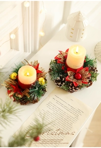 Close-up of Christmas candle holder with pine cones and festive red star decorations