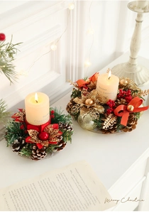 Christmas candle holder with pine cones, red berries, and cream pillar candles for decor
