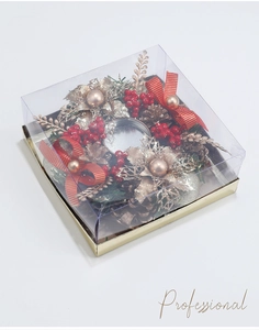 Macro detail of Christmas candle holder with pine cones and golden flowers in gift box