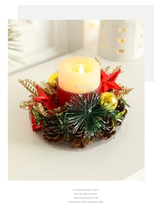 Close-up of Christmas candle holder with pine cones, golden leaves and red berries decor
