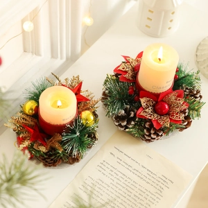 Christmas candle holder wreath with natural pine cones, red flowers and gold ornaments