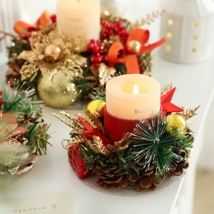 Christmas candle holder wreath with pinecones, red berries, and yellow pillar candle