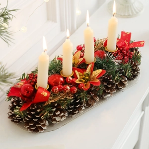 Christmas pine cone candle holder with four white candles and festive red berries decor