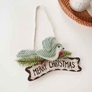 Green corduroy bird Christmas ornament with snowy pine branch and Merry Christmas sign