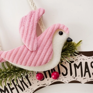 Close-up of fabric Christmas bird ornament with Merry Christmas sign and red berries