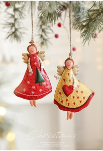 Detail of vintage iron Christmas angel ornaments with hand-painted finish and jute ropes