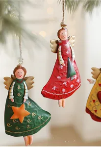 Macro shot of colorful vintage iron angel ornaments with festive patterns and jute string