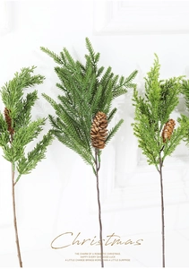 Close-up of artificial pine needles with realistic brown pine cones for Christmas decor