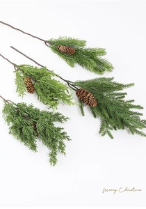 Detailed view of artificial green pine branches with realistic pine cones for Christmas decor