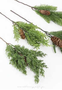 Detailed view of realistic artificial pine branches with natural pine cones for Christmas décor
