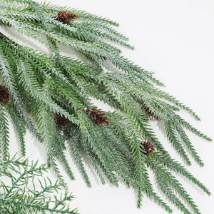 Artificial Christmas snowy pine branch with red berries and cones for holiday decoration