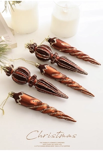 Close-up of retro bronze Christmas ornaments with glitter details on a festive background