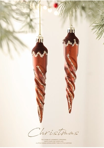 Macro detail of brown spiral icicle ornament with flocking and silver glitter on tree