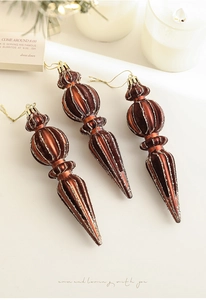 Detailed view of bronze icicle ornaments with flocking and silver glitter lines