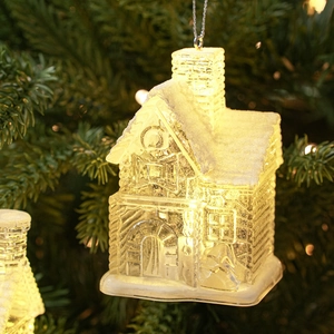 Luminous transparent Christmas house ornament with warm LED light and snow finish on tree
