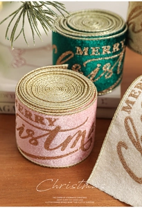 Detail of velvet Merry Christmas ribbons with gold glitter edges and festive prints