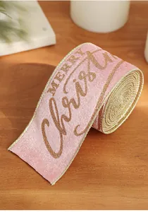 Detailed macro view of pink velvet Merry Christmas ribbon with gold glitter text and edges