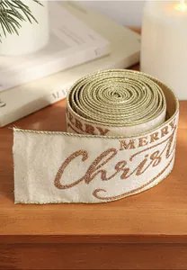 Detailed texture of champagne gold Merry Christmas ribbon with glitter and velvet finish