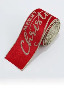 Detail of red velvet Christmas ribbon with golden glitter Merry Christmas lettering