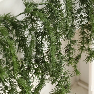 Artificial pine vine garland with cones hanging on wall for Christmas and home decor