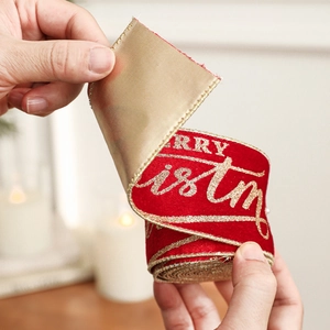 Red flocked Christmas ribbon with gold Merry Christmas lettering and wired edges