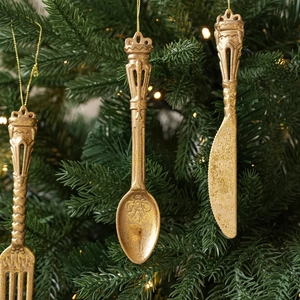 Close-up of vintage gold cutlery Christmas tree ornaments with crown top details