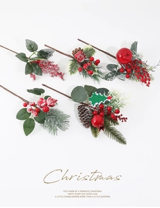 Close-up of artificial frosted pine branches with red berries and pinecones for Christmas decor