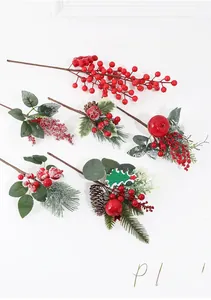 Macro detail of artificial Christmas picks with red berries, pine cones and snowy needles