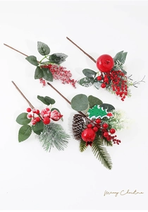 Detailed view of assorted Christmas picks featuring red berries, snow pine needles and cones