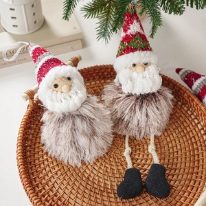 Charming plush Christmas gnomes decorations with knitted hats and fur bodies in warm setting