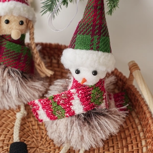 Plush Christmas gnome dolls with knit hats and faux fur beards in cozy basket decor