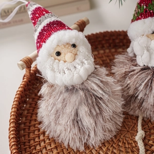 Detail of Santa gnome plush hanging ornament with striped hat and white beard