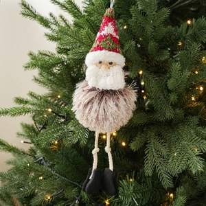 Detail of Santa plush ornament with knitted hat and faux fur beard hanging on Christmas tree