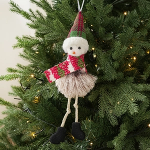 Detail of Christmas elf plush pendant with a red checkered hat on a festive tree branch